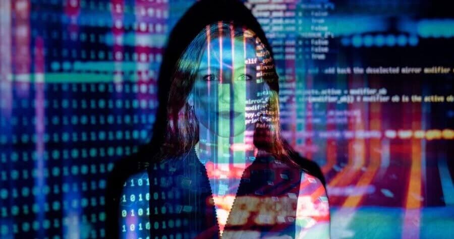 Woman standing in front of code to represent how overwhelmed she would be if she had to develop and design a website by herself, with no professionals.